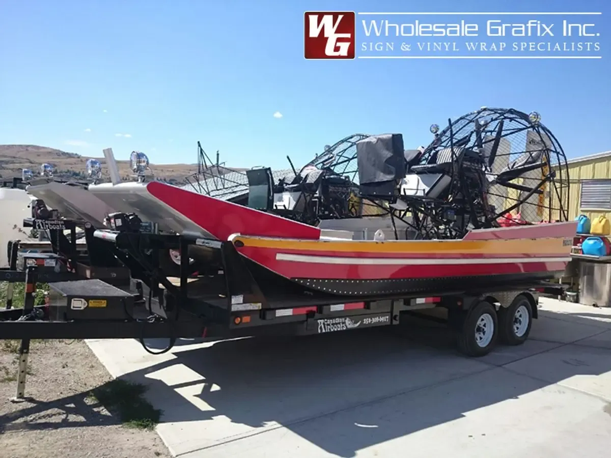 Red jet boat on a trailer with wrapped hull graphics