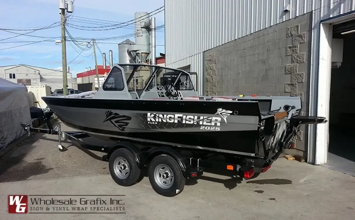 Black KingFisher jet boat on a trailer with hull decals