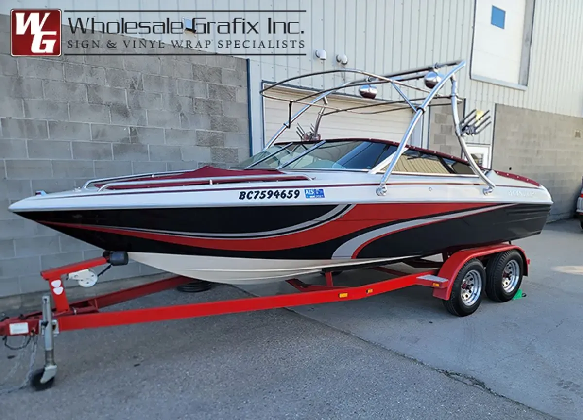 Red and white ski boat with wrapped hull graphics