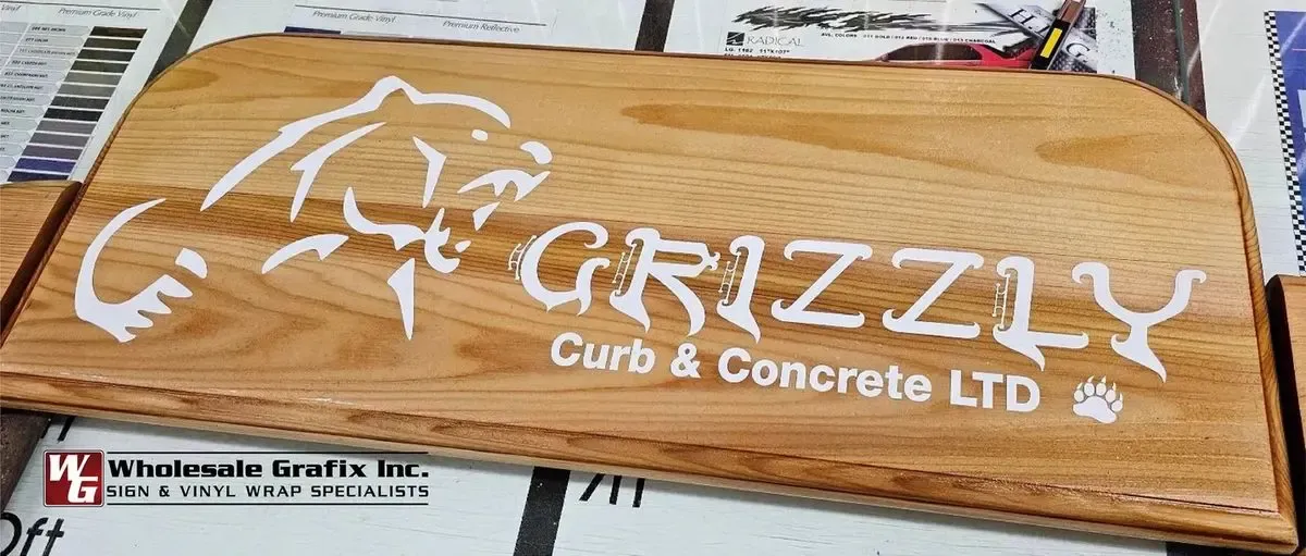 Grizzly Curb and Concrete wood sign with a bear graphic