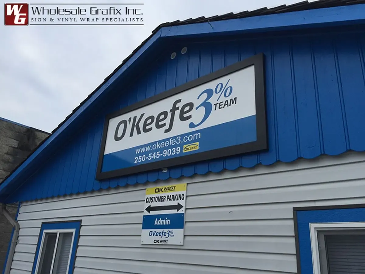 O'Keefe 3% Team building sign mounted on blue steel siding