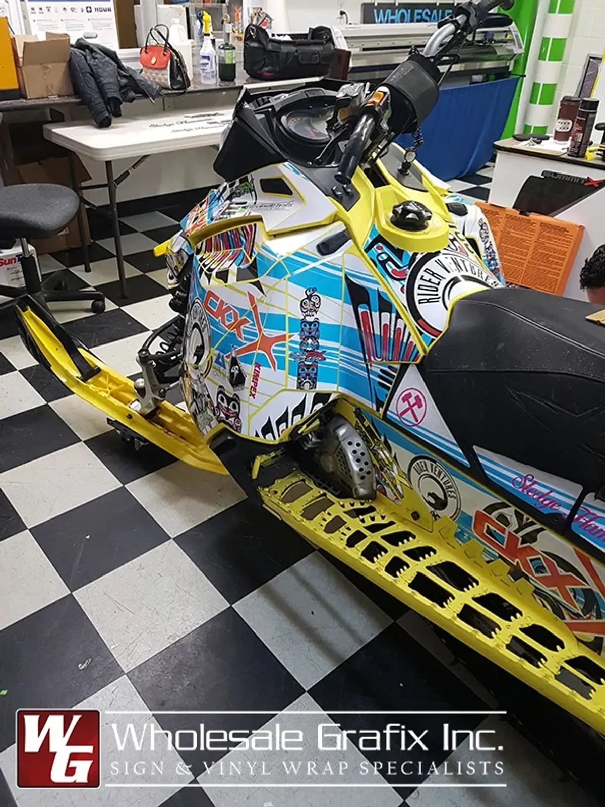 Snowmobile wrapped in a yellow comic-panel art design