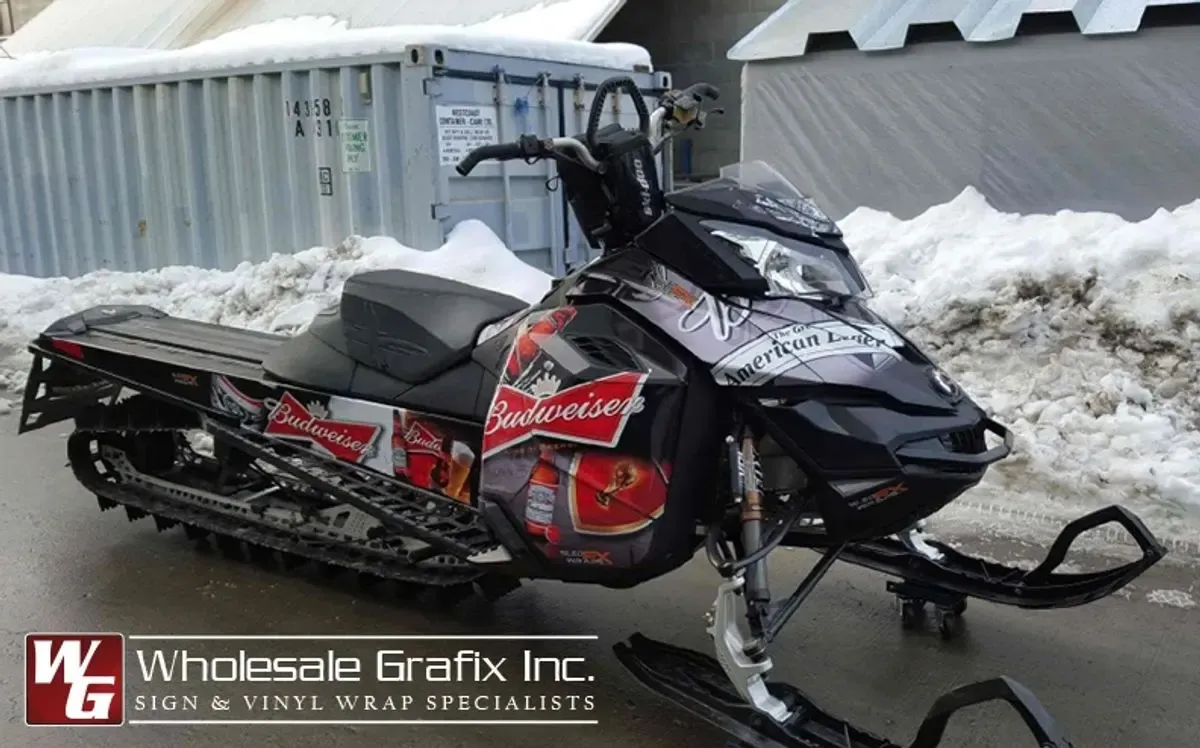 Snowmobile carrying a full sponsor livery wrap