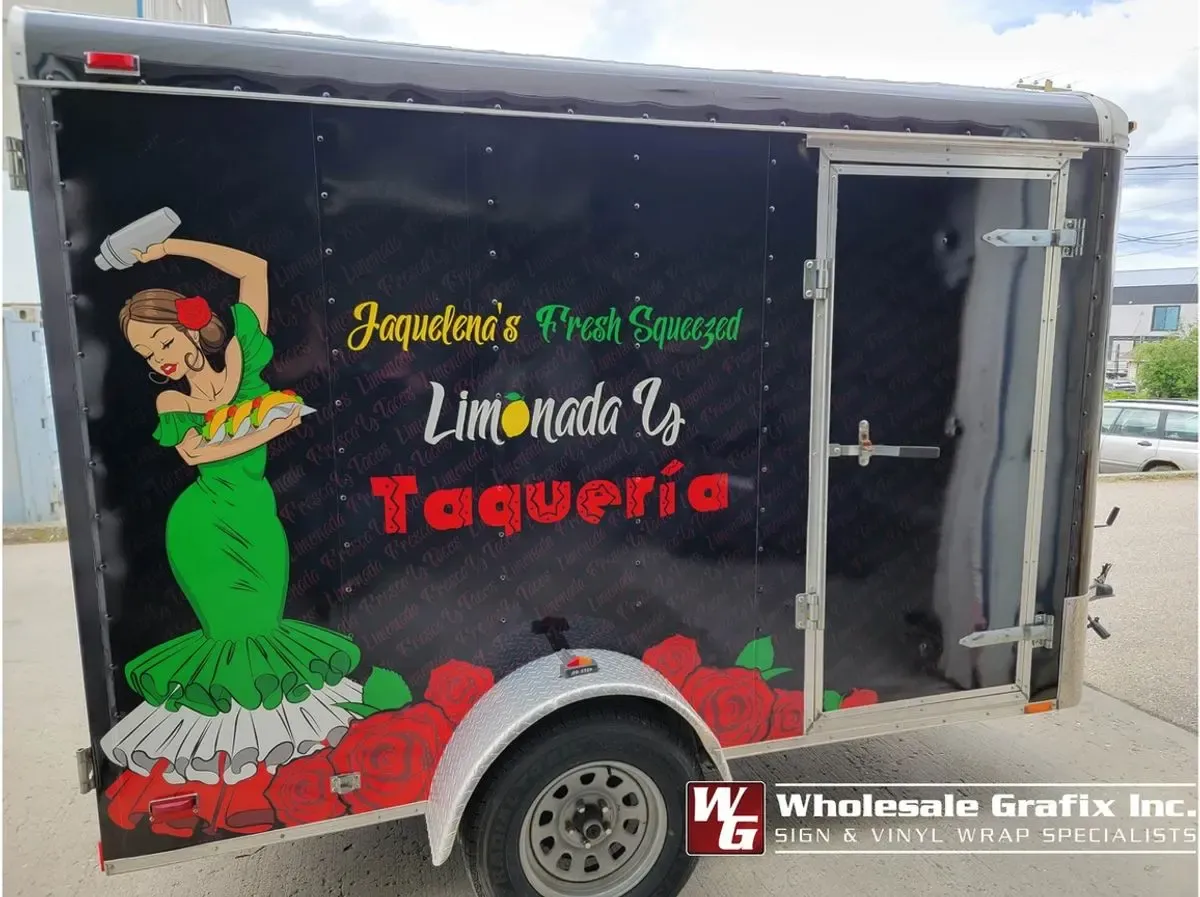 Utility trailer with cut vinyl lettering along the flank
