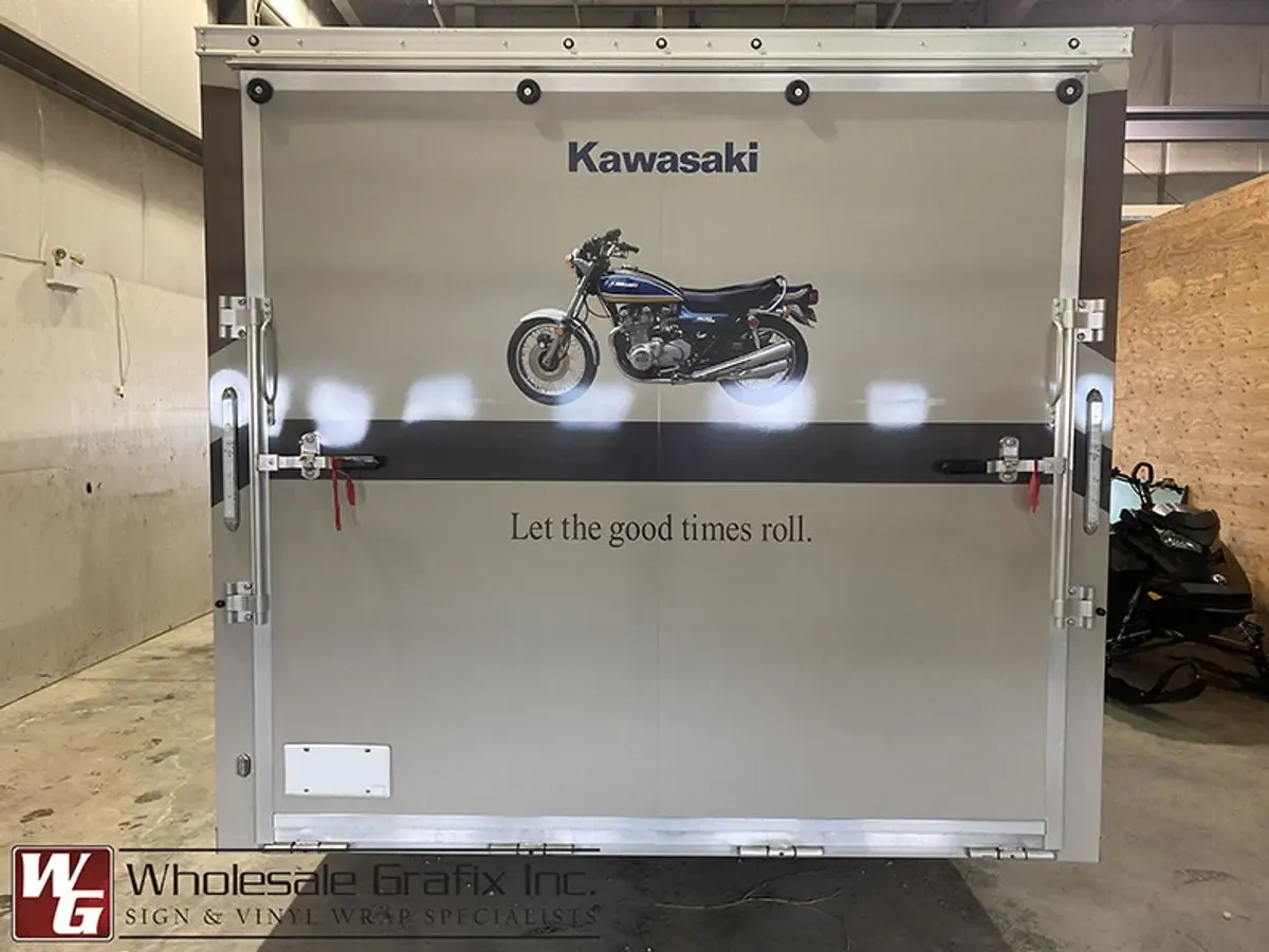 Wrapped work trailer with company contact details on the panel