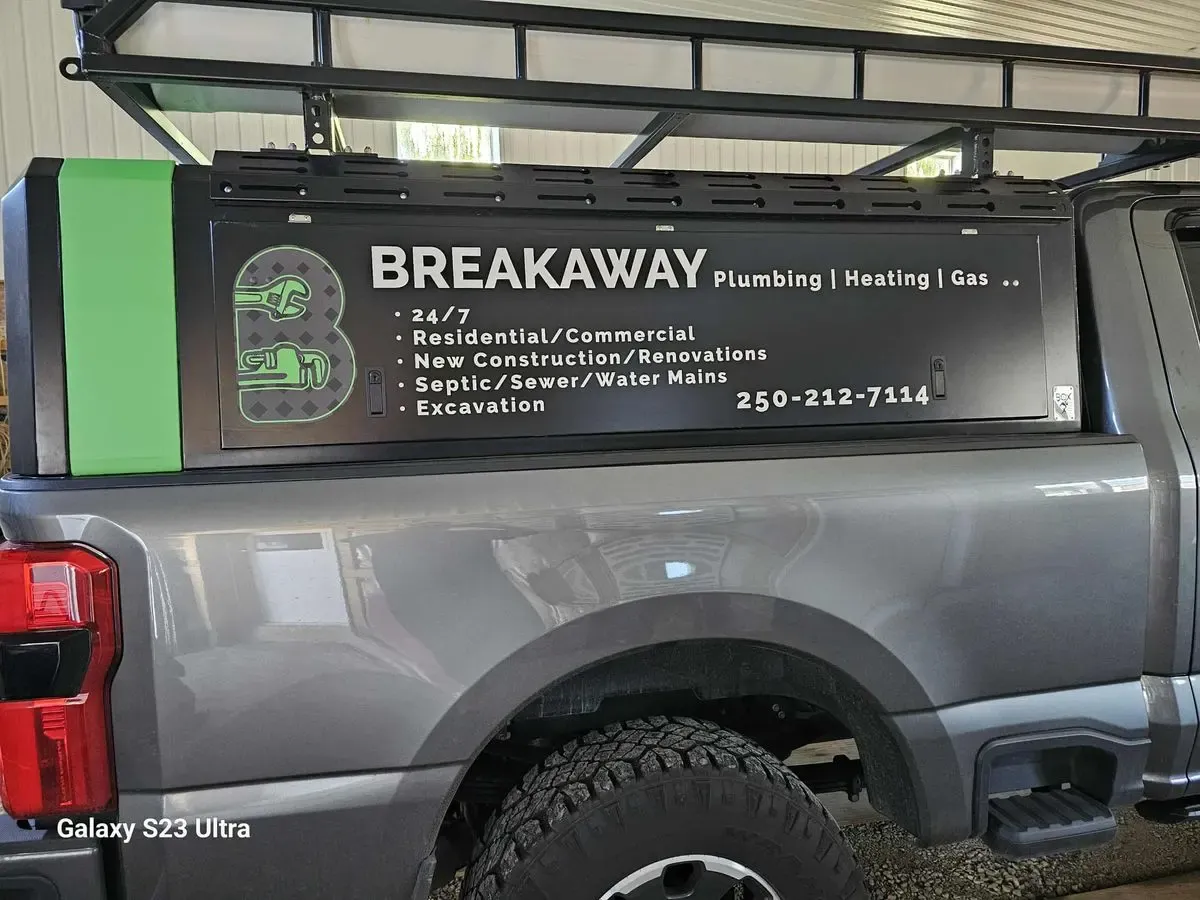 Breakaway Plumbing truck canopy with service listing decals