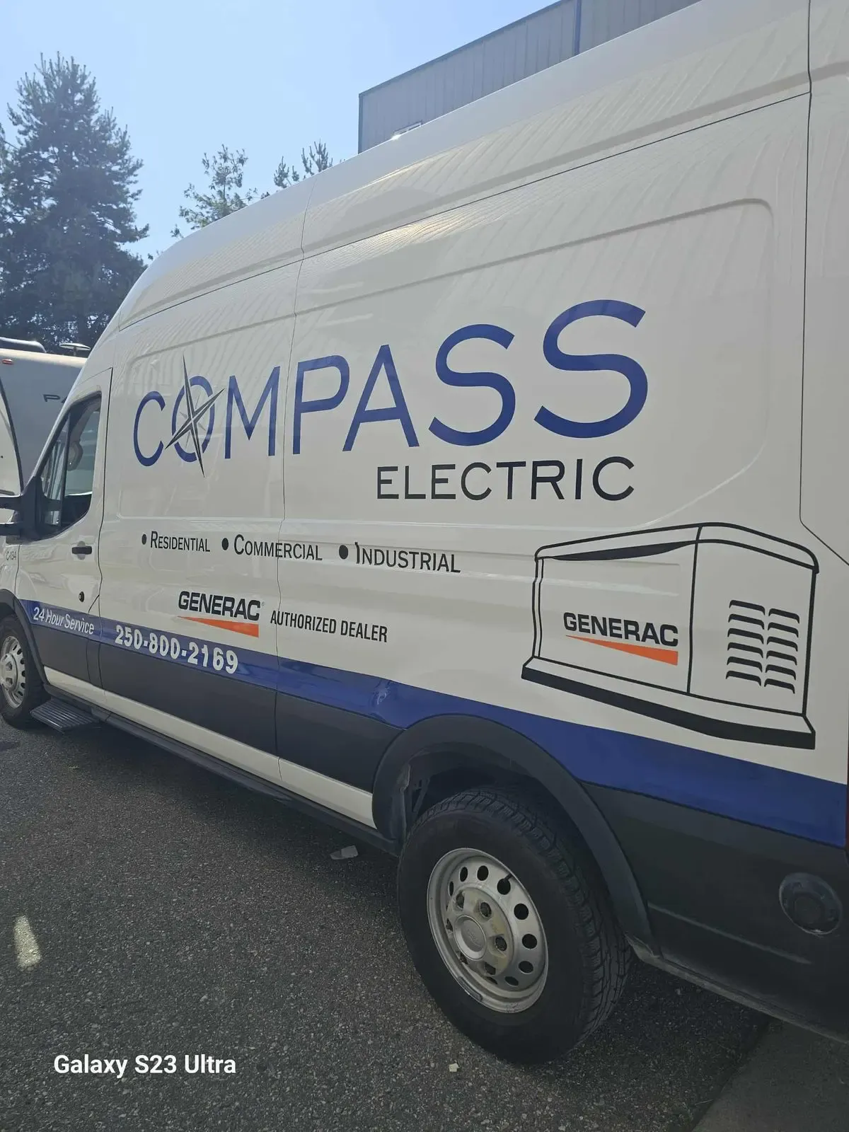 Compass Electric van wrapped with blue compass branding