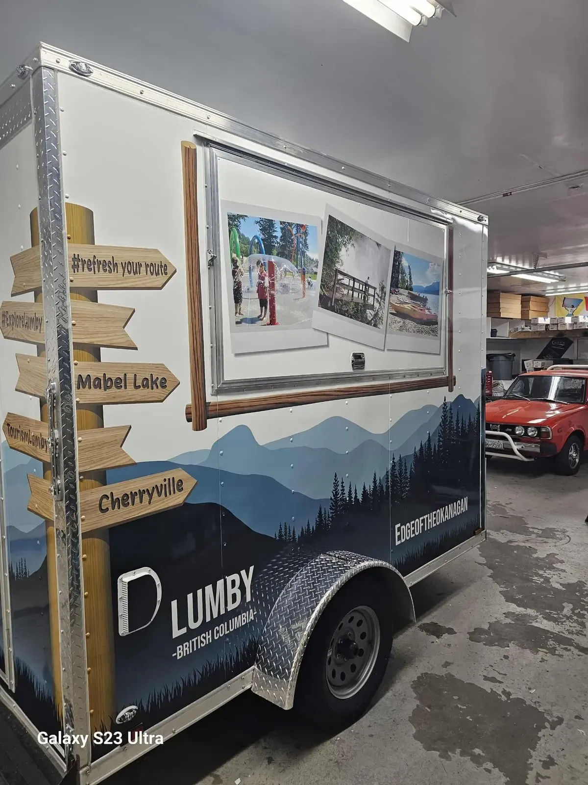 Lumby BC tourism trailer wrapped with a painted mountain landscape